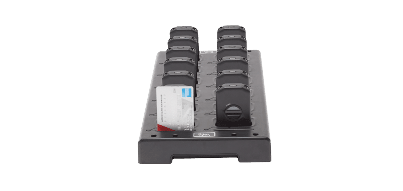 12 unit charging tray holding iDSP receivers and a credit card to show size