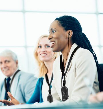 Business forum attendee with assistive listening device